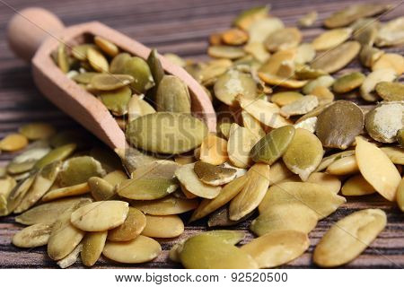 Pumpkin Seeds With Spoon On Wooden Background