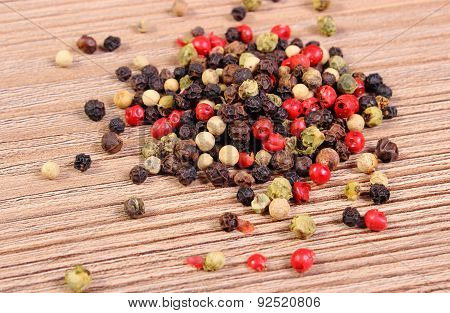 Heap Of Fresh Colored Pepper On Wooden Background