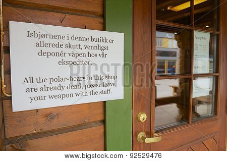 Information sign at the entrance to the souvenir shop in Longyearbyen, Norway.