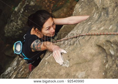 Beautiful Woman Climbing On Rock
