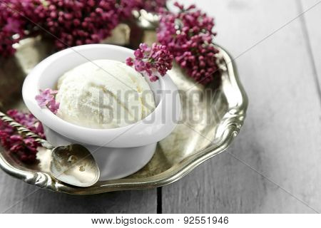 Beautiful composition with tasty ice cream and lilac flowers