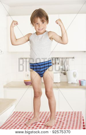 Boy Standing On Kitchen Table In Underwear