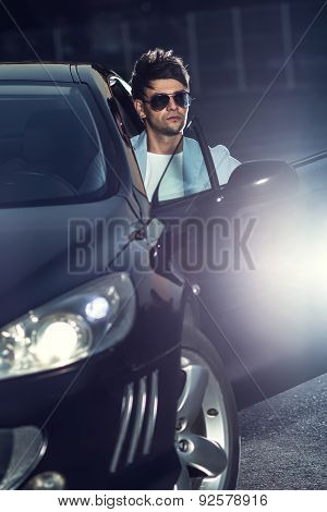 Handsome Young Man Sit In His Car. Gorgeous Guy With Eyeglasses. Outdoors - Outside
