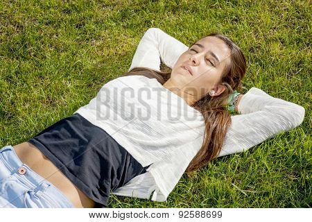 Beautiful Teenager Lying On The Grass