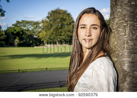 Beautiful Teenager Leaning On A Tree