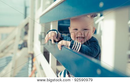 Little baby girl laughing on a beach house