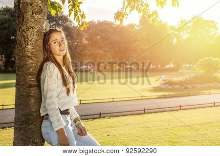 Beautiful Teenager Leaning On A Tree
