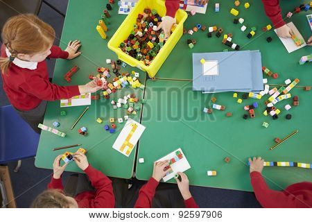 Overhead View Of Pupils Working With Coloured Blocks