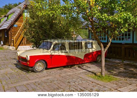 DRVENGRAD, SERBIA - SEPTEMBER 03: Retro cars in traditional village Drvengrad Mecavnik on September 03, 2015 in Drvengrad, Serbia.