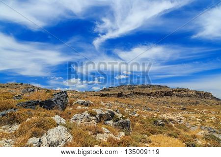 Mountain clouds igneous rock sunny day Greek