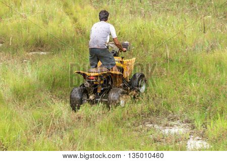 Off Road On 4X4 Quad Bike Through Mud Puddle