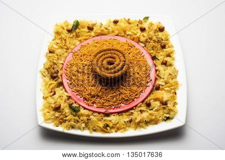 design created using diwali food or diwali snacks, chivda or chiwda, chakali or chakli, besan sev, front angle closeup