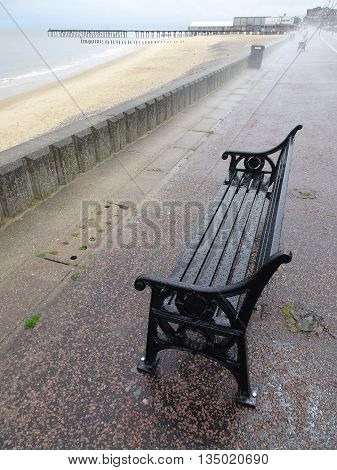Beach promenade benches and pier photographed at Lowestoft in Norfolk