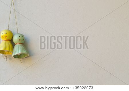 Teru Teru bozu on white old wall background