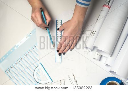 Architect working on blueprint. Architects workplace - architectural project blueprints ruler and divider compass. Construction concept. Engineering tools. Top view