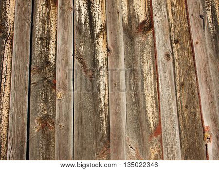 Wood slatted barn with old red paint