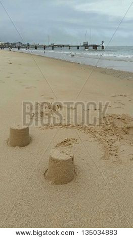 Sandcastles and pier seascape photographed at Lowestoft in Norfolk