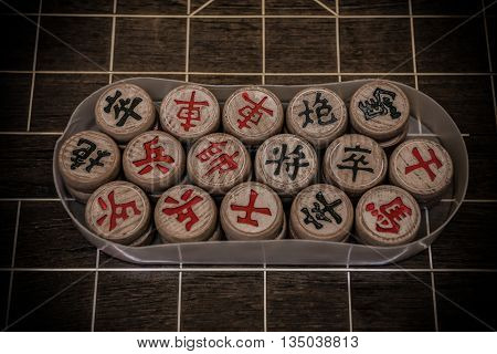 Chinese chesses in a plastic case on chessboardthey are Admiral General Cannons Elephants Advisors King Knights Rooks Pawns and chess is very commond and popula in China