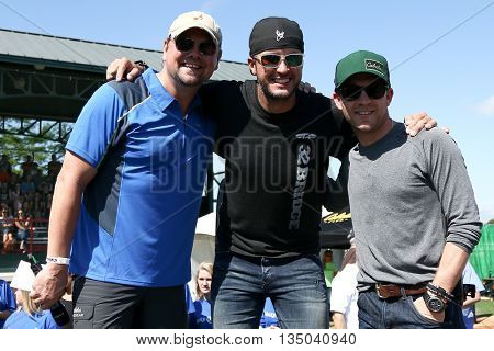 ARLINGTON, TX - APR 18: (L-R) Storme Warren, Luke Bryan and Justin Moore at the ACM & Cabela's Great Outdoor Archery Event at the Texas Rangers Youth Ballpark on April 18, 2015.