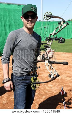ARLINGTON, TX - APR 18: Recording artist Justin Moore poses at the ACM & Cabela's Great Outdoor Archery Event at the Texas Rangers Youth Ballpark on April 18, 2015.