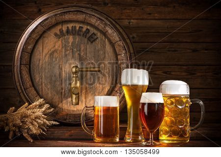 Beer barrel with beer glasses on wooden background