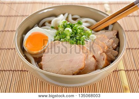 Japanese noodles Udon with chicken and boiled egg in soybean paste (Miso) soup on a mat