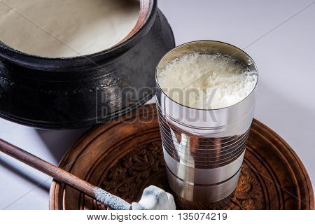 Herbal juice of green momodica in a glass with sliced vegetables, karela juice or bitter gourd juice