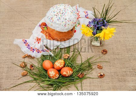 Homemade Easter cake and painted eggs on the table