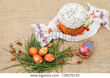 Homemade Easter cake and painted eggs on the table