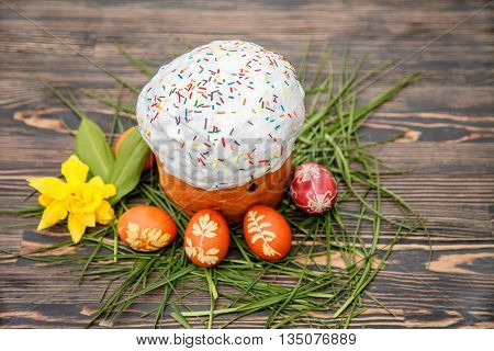 Homemade Easter cake and painted eggs on the table