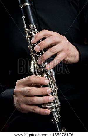 hands of a clarinet player in black