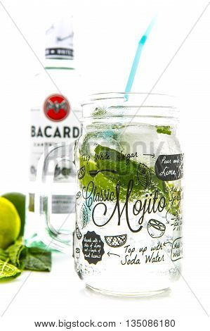 SWINDON UK - JUNE 20 2016: Classic Mojito cocktail in a Kilner Mason Jar with a bottle of Bacardi isolated on a white background