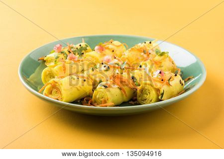 khandvi is a gujarati snack from India which is made with gram flour and curds tempered with sesame seeds and mustard seeds also known as Surali chya Vadya/Stuffed Khandvi, selective focus