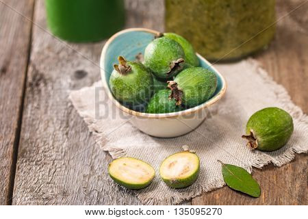 Fresh fruits of feijoa in abowl and feijoa jam on wooden table