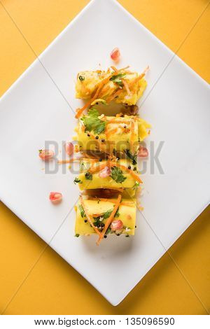 khandvi is a gujarati snack from India which is made with gram flour and curds tempered with sesame seeds and mustard seeds also known as Surali chya Vadya/Stuffed Khandvi, selective focus