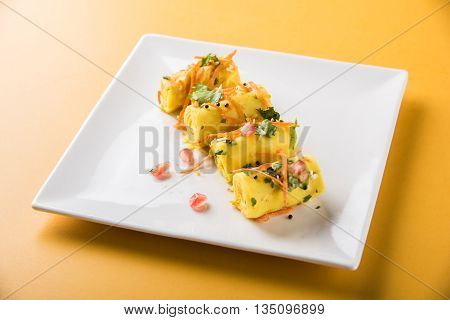 khandvi is a gujarati snack from India which is made with gram flour and curds tempered with sesame seeds and mustard seeds also known as Surali chya Vadya/Stuffed Khandvi, selective focus