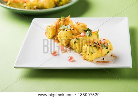 khandvi is a gujarati snack from India which is made with gram flour and curds tempered with sesame seeds and mustard seeds also known as Surali chya Vadya/Stuffed Khandvi, selective focus