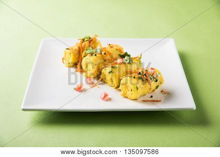 khandvi is a gujarati snack from India which is made with gram flour and curds tempered with sesame seeds and mustard seeds also known as Surali chya Vadya/Stuffed Khandvi, selective focus
