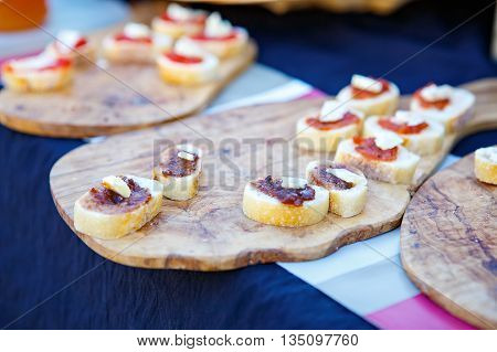 Different tapenade of black and green olives with garlic bread on provencal street market in Provence, France. Selling and buying. Healthy organic local food market.