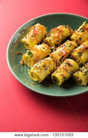 khandvi is a gujarati snack from India which is made with gram flour and curds tempered with sesame seeds and mustard seeds also known as Surali chya Vadya/Stuffed Khandvi, selective focus