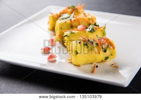 khandvi is a gujarati snack from India which is made with gram flour and curds tempered with sesame seeds and mustard seeds also known as Surali chya Vadya/Stuffed Khandvi, selective focus