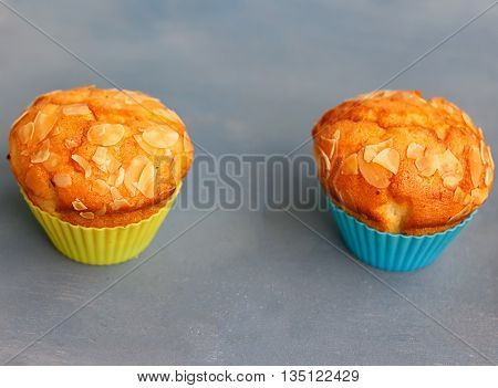 Muffins in silicone tins on a blue background