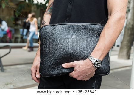 MILAN ITALY - JUNE 18: Detail of bag outside Jil Sander fashion show building for Milan Men's Fashion Week on JUNE 18 2016 in Milan.