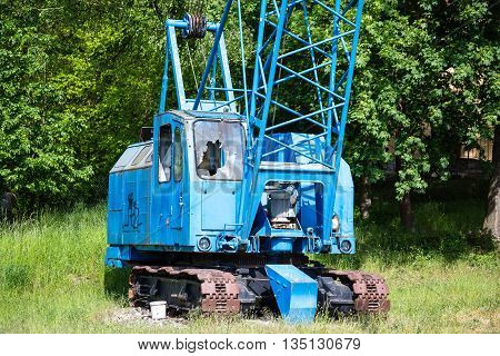 Detail of an old crane against a cloudy sky