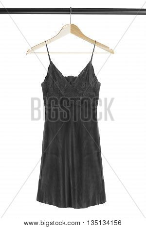 Black silk nightdress on wooden clothes rack isolated over white