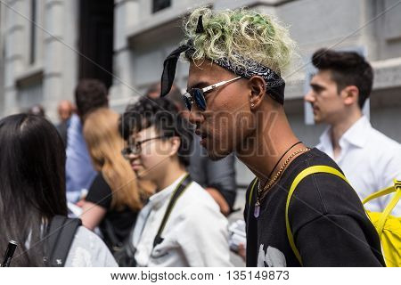 MILAN ITALY - JUNE 18: Fashionable man poses outside Marni fashion show building for Milan Men's Fashion Week on JUNE 18 2016 in Milan.