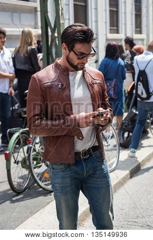 MILAN ITALY - JUNE 18: Fashionable man poses outside Marni fashion show building for Milan Men's Fashion Week on JUNE 18 2016 in Milan.