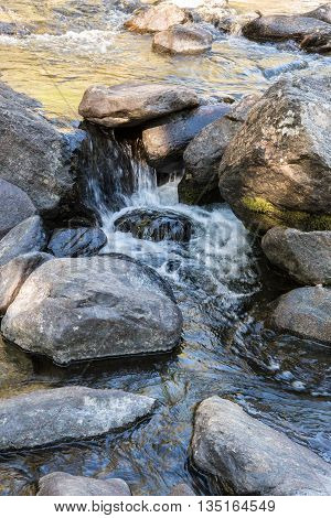 Rapid flow of the Chulcha river near Uchar waterfall, Altai, Russia