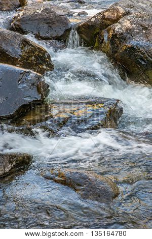 Rapid flow of the Chulcha river near Uchar waterfall, Altai, Russia