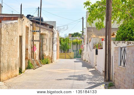 The narrow street with old houses in the historic part of Hersonissos Crete Greece.